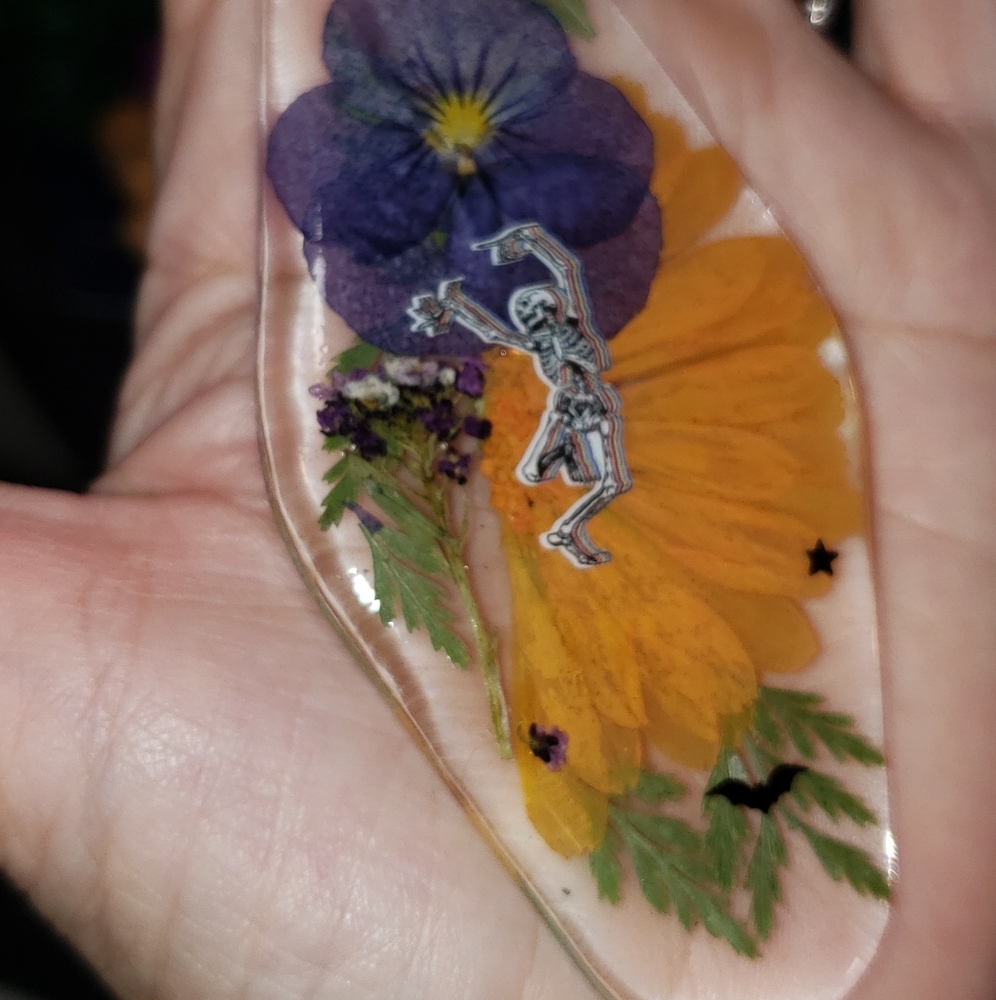 Handcrafted Floral Resin Keychain with Skeleton Dancing Design.